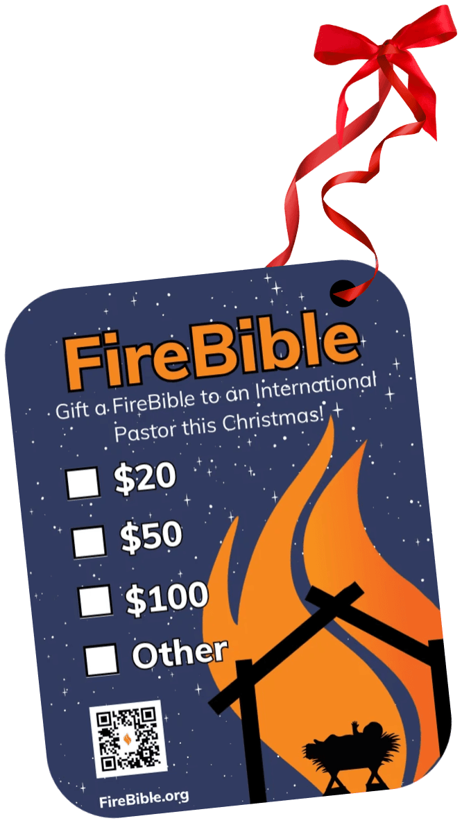 FireBible ornament, back: the giving side, reading “Gift a FireBible to an International Pastor this Christmas!” with tick boxes, a QR code and the FireBible.org address.